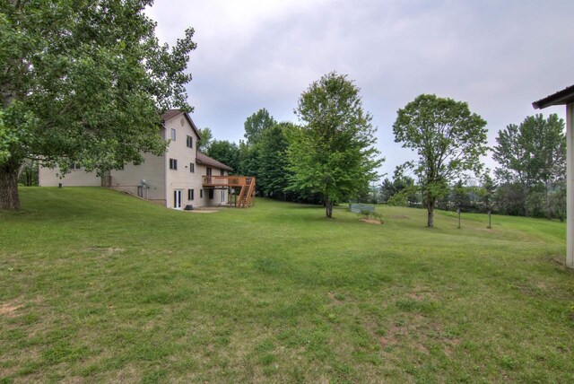 8103 W Folsom St, Eau Claire, WI 54703 - view of green lawn with a wooden deck
