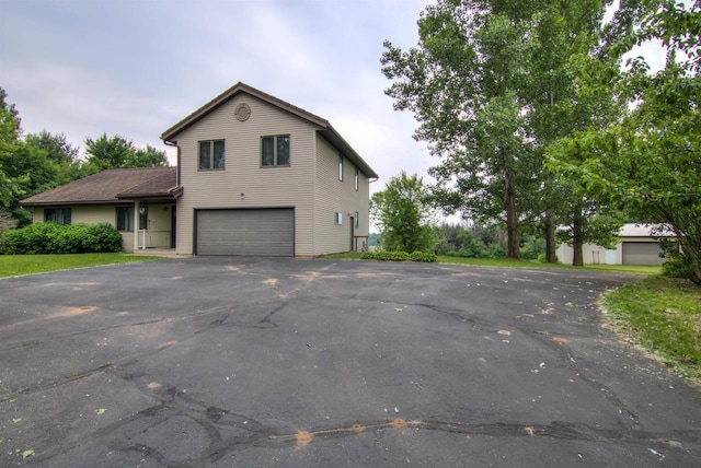 8103 W Folsom St, Eau Claire, WI 54703 - view of front of property featuring an attached garage and asphalt driveway