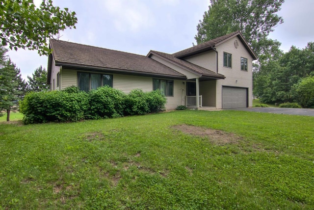 8103 W Folsom St, Eau Claire, WI 54703 - view of front of house featuring an attached garage, driveway, and a front lawn