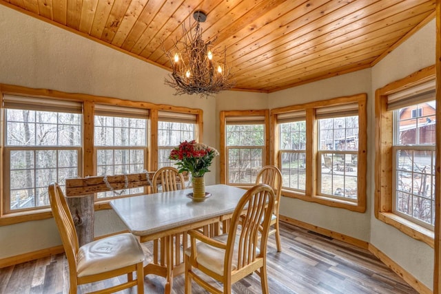 7760 N Thunder Point Rd, Hayward, WI 54843 - dining area with a chandelier, healthy amount of natural light, light wood-style flooring, wood ceiling, and a textured wall