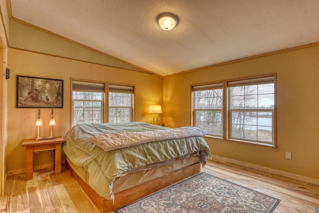 7760 N Thunder Point Rd, Hayward, WI 54843 - bedroom with vaulted ceiling, wood finished floors, a textured ceiling, and ornamental molding