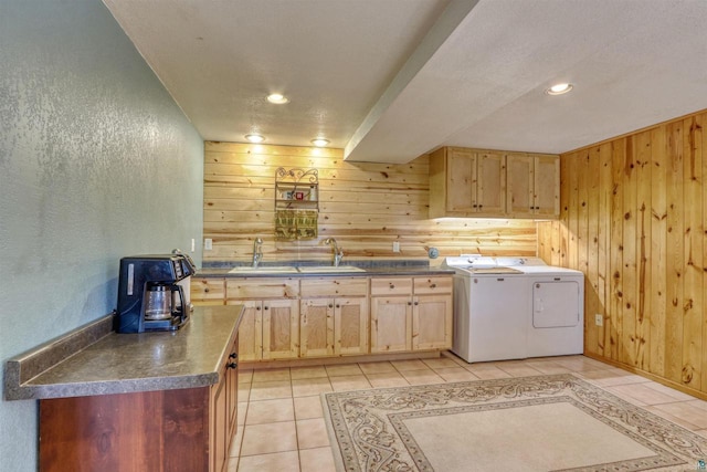 7760 N Thunder Point Rd, Hayward, WI 54843 - kitchen with a textured wall, wood walls, independent washer and dryer, light brown cabinetry, and dark countertops