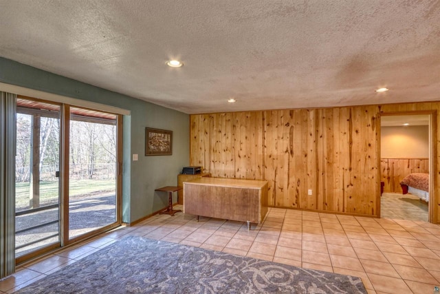 7760 N Thunder Point Rd, Hayward, WI 54843 - kitchen with a textured ceiling, wood walls, recessed lighting, and tile patterned flooring