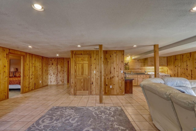 7760 N Thunder Point Rd, Hayward, WI 54843 - living area featuring wooden walls, a textured ceiling, light tile patterned floors, and recessed lighting
