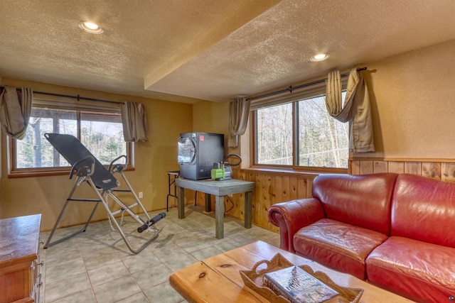 7760 N Thunder Point Rd, Hayward, WI 54843 - living area featuring a textured ceiling, wooden walls, recessed lighting, and light tile patterned floors