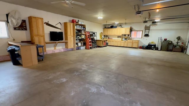 7760 N Thunder Point Rd, Hayward, WI 54843 - garage with a garage door opener and a ceiling fan