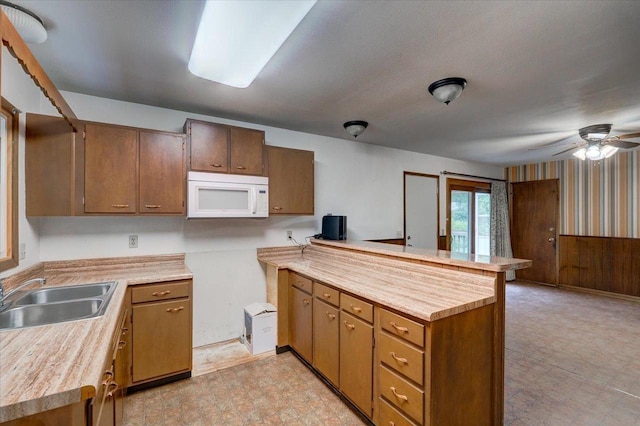 1702 Rae Ln, Madison, WI 53711 - kitchen with white microwave, a peninsula, light floors, and light countertops