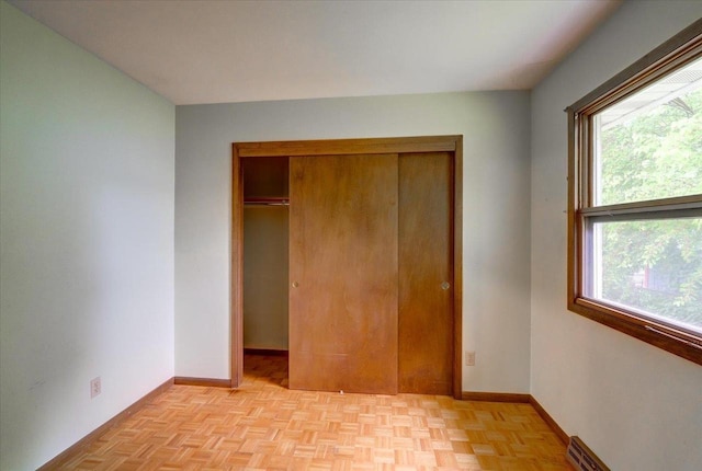 1702 Rae Ln, Madison, WI 53711 - unfurnished bedroom with multiple windows, a closet, and baseboard heating
