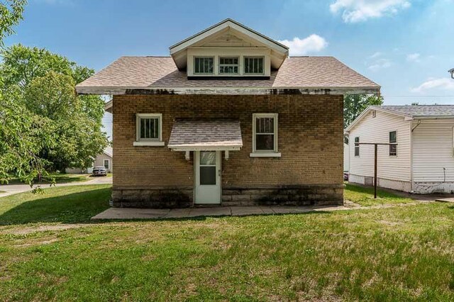619 Middle St, Beloit, WI 53511 - back of house featuring a yard and brick siding