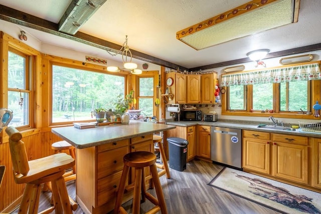 N8981 W Island Rd, Phillips, WI 54555 - kitchen with stainless steel dishwasher, light wood-type flooring, black microwave, a kitchen breakfast bar, and a center island