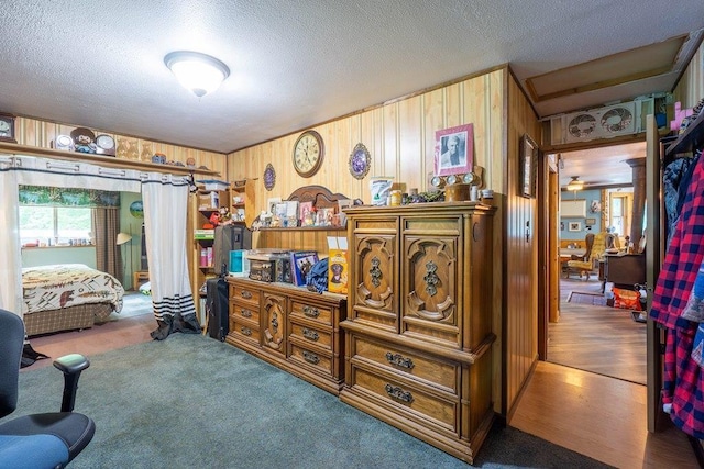 N8981 W Island Rd, Phillips, WI 54555 - bedroom featuring a textured ceiling, wood walls, and carpet floors
