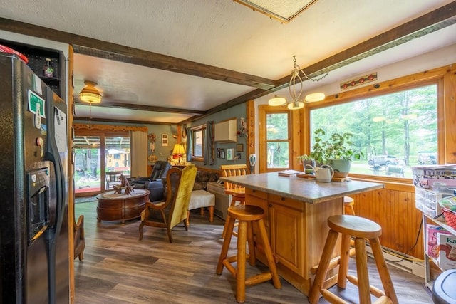 N8981 W Island Rd, Phillips, WI 54555 - dining space with wood finished floors, beam ceiling, baseboard heating, and a textured ceiling