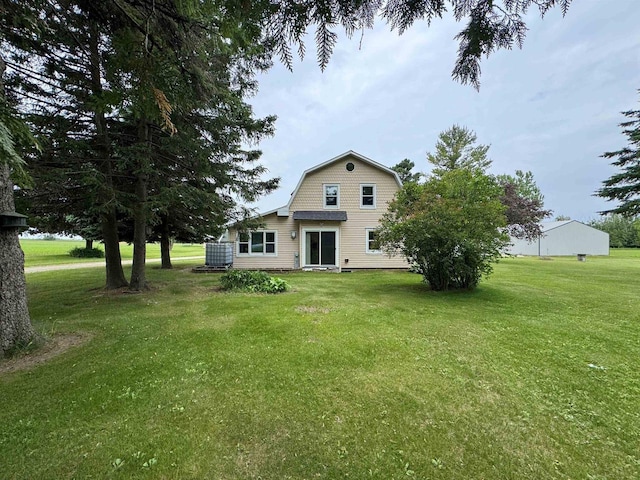 7376 Neils Rd, Sturgeon Bay, WI 54235 - rear view of house featuring a gambrel roof and a lawn