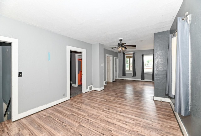 1721 Spring Pl, Racine, WI 53404 - spare room featuring wood finished floors, a ceiling fan, and a textured ceiling
