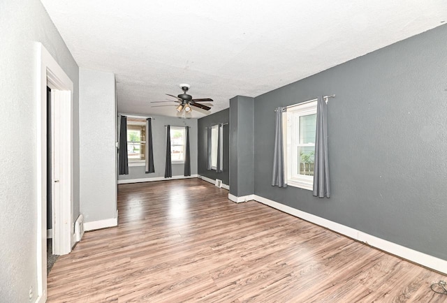 1721 Spring Pl, Racine, WI 53404 - spare room with wood finished floors, ceiling fan, and a textured wall