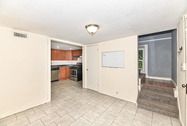 1721 Spring Pl, Racine, WI 53404 - unfurnished living room with a textured ceiling, stairs, and light tile patterned floors