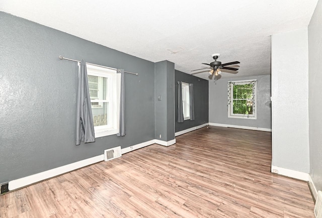 1721 Spring Pl, Racine, WI 53404 - empty room featuring wood finished floors, ceiling fan, a textured wall, and a textured ceiling