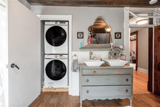 508 Evergreen St, Colfax, WI 54730 - washroom with stacked washing machine and dryer and wood finished floors
