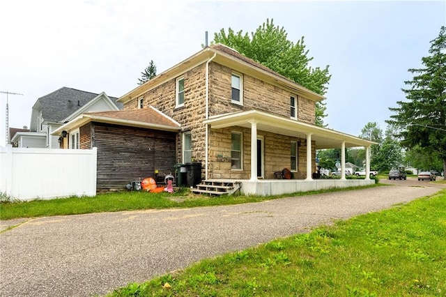 508 Evergreen St, Colfax, WI 54730 - rear view of property with a porch and stone siding