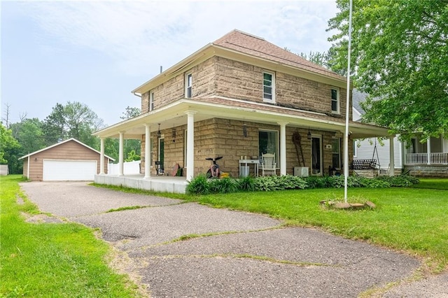 508 Evergreen St, Colfax, WI 54730 - farmhouse inspired home with a porch, an outbuilding, a garage, a front lawn, and stone siding