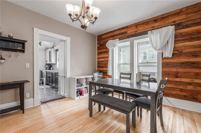 508 Evergreen St, Colfax, WI 54730 - dining space with a chandelier, light wood-style floors, and wood walls