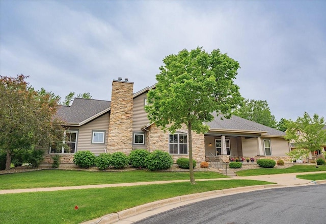 8201 Highview Dr, Madison, WI 53719 - view of front of home with stone siding, a chimney, a front lawn, and covered porch