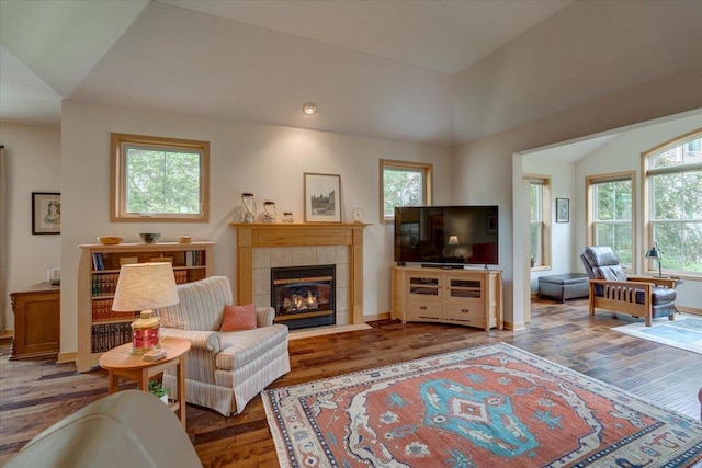 8201 Highview Dr, Madison, WI 53719 - living area featuring wood finished floors, plenty of natural light, a tile fireplace, vaulted ceiling, and recessed lighting