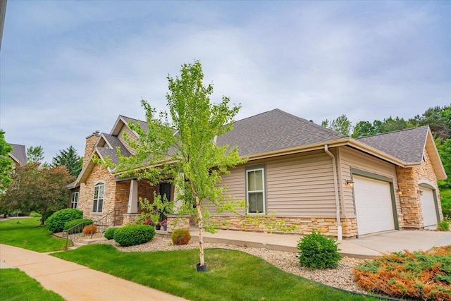 8201 Highview Dr, Madison, WI 53719 - craftsman-style home featuring stone siding, a shingled roof, a garage, a front lawn, and concrete driveway