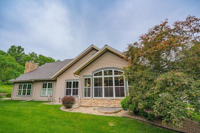 8201 Highview Dr, Madison, WI 53719 - rear view of house featuring a chimney, a lawn, and stone siding