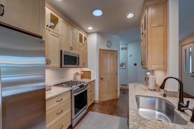 8201 Highview Dr, Madison, WI 53719 - kitchen with stainless steel appliances, glass insert cabinets, dark wood finished floors, backsplash, and light brown cabinets