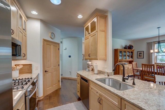 8201 Highview Dr, Madison, WI 53719 - kitchen with appliances with stainless steel finishes, dark wood finished floors, light brown cabinetry, glass insert cabinets, and light stone countertops