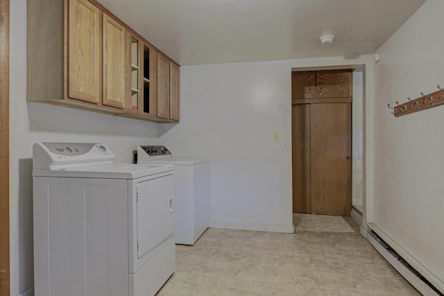 66 Torrey St, Clintonville, WI 54929 - laundry area featuring a baseboard heating unit, washer and dryer, and cabinet space