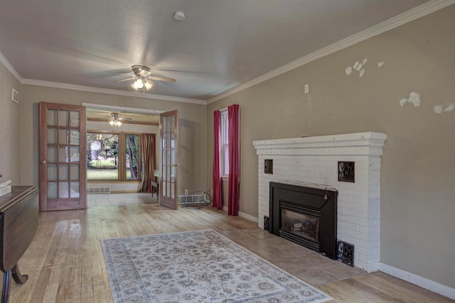 66 Torrey St, Clintonville, WI 54929 - unfurnished living room featuring french doors, ceiling fan, hardwood / wood-style flooring, a brick fireplace, and ornamental molding