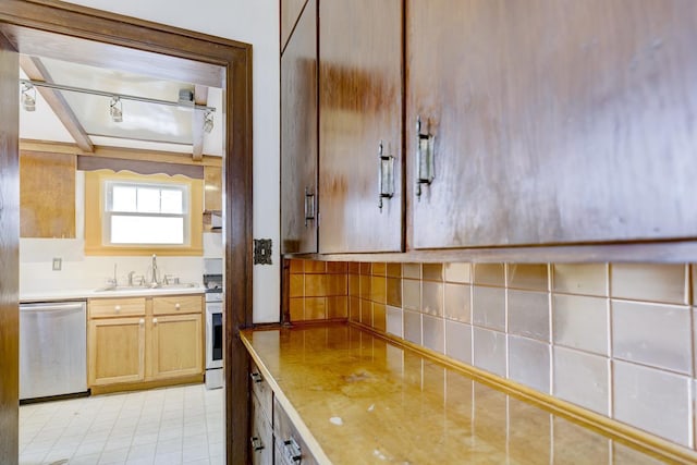518 Maple Ave, Madison, WI 53704 - kitchen featuring dishwasher, track lighting, light countertops, white stove, and tasteful backsplash