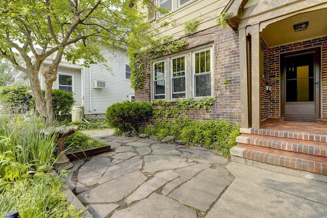 518 Maple Ave, Madison, WI 53704 - view of exterior entry featuring brick siding and a wall unit AC