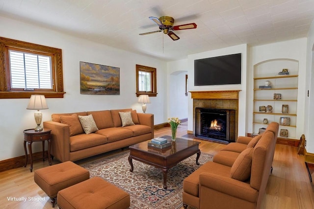 518 Maple Ave, Madison, WI 53704 - living area featuring light wood-type flooring, a ceiling fan, built in features, and a tile fireplace