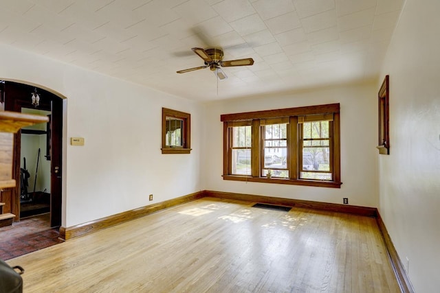518 Maple Ave, Madison, WI 53704 - unfurnished room with arched walkways, a ceiling fan, and wood finished floors