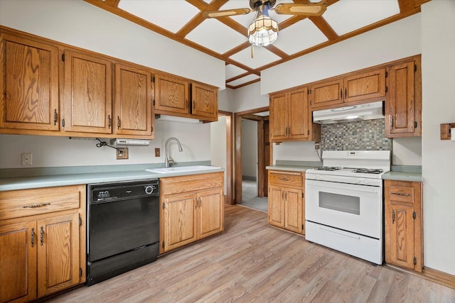 2140 N 64th St, Wauwatosa, WI 53213 - kitchen featuring dishwasher, white range with gas cooktop, under cabinet range hood, tasteful backsplash, and light countertops
