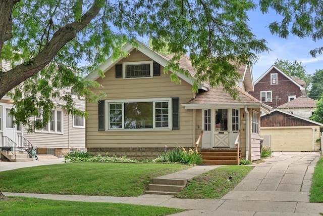 2140 N 64th St, Wauwatosa, WI 53213 - view of front of home featuring entry steps, an outdoor structure, a front lawn, and a garage