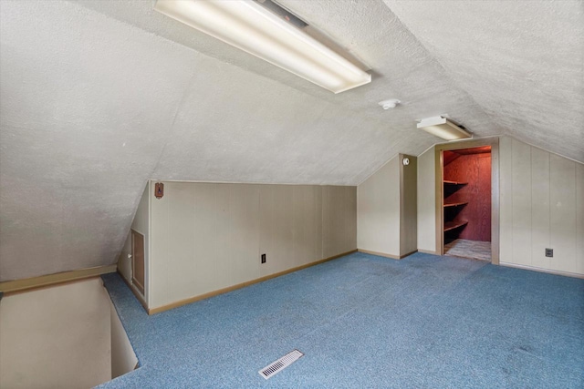 2140 N 64th St, Wauwatosa, WI 53213 - bonus room featuring a textured ceiling, lofted ceiling, and carpet flooring