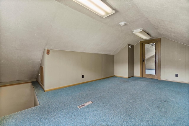 2140 N 64th St, Wauwatosa, WI 53213 - bonus room with a textured ceiling, lofted ceiling, and carpet floors