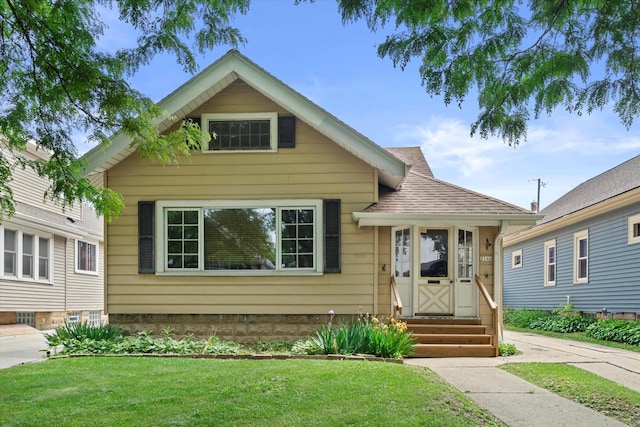2140 N 64th St, Wauwatosa, WI 53213 - view of front of property featuring a front lawn, roof with shingles, and entry steps