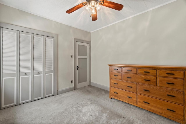 2140 N 64th St, Wauwatosa, WI 53213 - bedroom with light colored carpet, ornamental molding, a closet, and a ceiling fan
