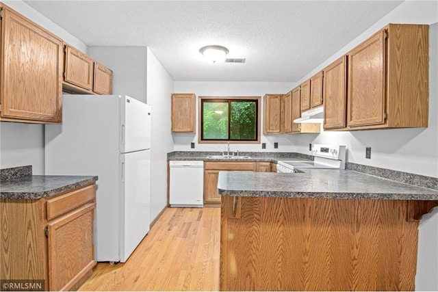 1754 Helena Rd, Oakdale, MN 55128 - kitchen with white appliances, a peninsula, under cabinet range hood, dark countertops, and a textured ceiling
