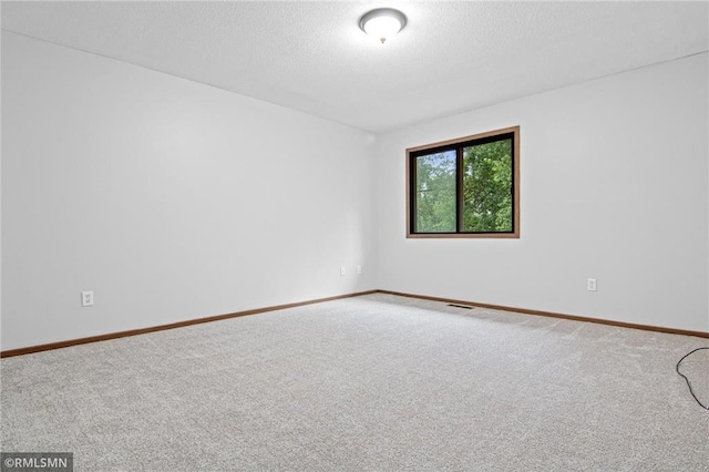 1754 Helena Rd, Oakdale, MN 55128 - carpeted spare room with baseboards and a textured ceiling