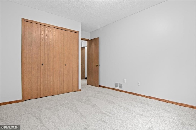 1754 Helena Rd, Oakdale, MN 55128 - unfurnished bedroom with carpet, a closet, and a textured ceiling