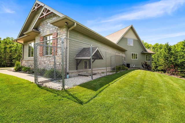 14595 Louis Corners Rd, Kiel, WI 53042 - view of home's exterior with stone siding and a lawn
