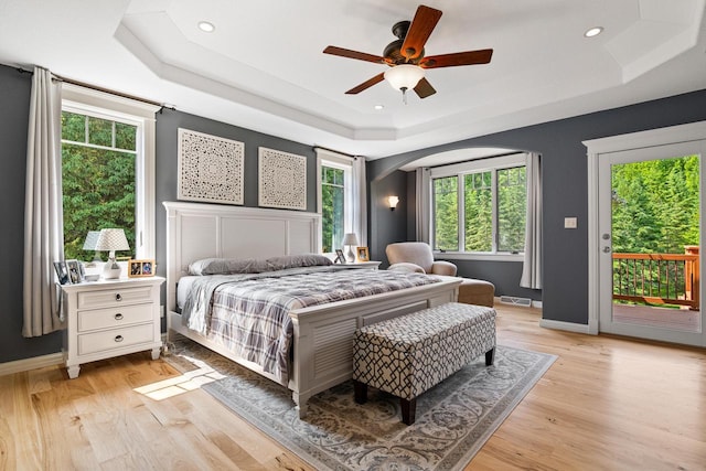 14595 Louis Corners Rd, Kiel, WI 53042 - bedroom with a raised ceiling, access to outside, light wood-style floors, and a ceiling fan