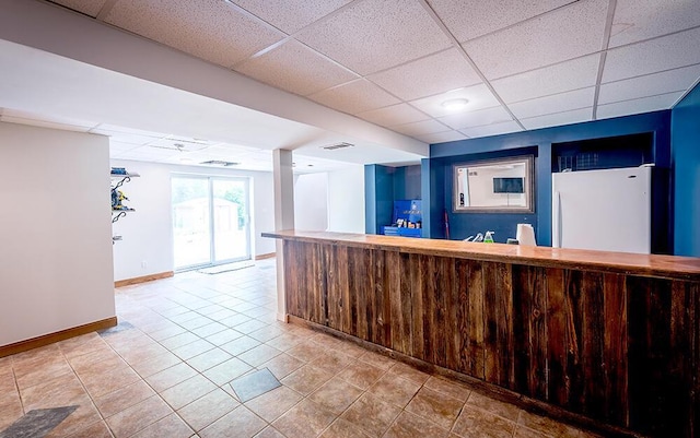 11812 Fox River Rd, Twin Lakes, WI 53181 - indoor bar with freestanding refrigerator, a paneled ceiling, and light tile patterned floors