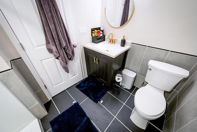 11812 Fox River Rd, Twin Lakes, WI 53181 - bathroom featuring vanity, tile patterned floors, tile walls, and a wainscoted wall